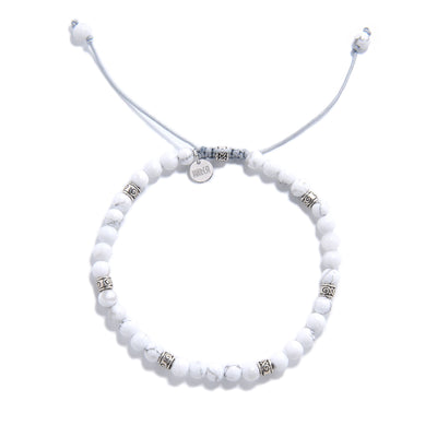 Elegant white crystal bracelet with round beads and silver details
