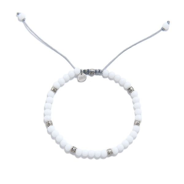 Top view of White Jade Bracelet for men with white beads, silver spacers, gray cord, and charm.