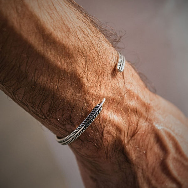 Silver mens bracelet worn on wrist showing its handcrafted pattern and fit