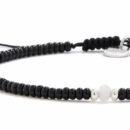 Detailed view of Bead Bracelet Black with black seed beads with white accent beads, seed bead texture, and cord knot