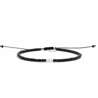 Bead Bracelet Black shown in full view with black seed beads with white accent beads and adjustable cord