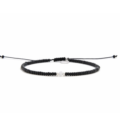 Bead Bracelet Black shown in full view with black seed beads with white accent beads and adjustable cord