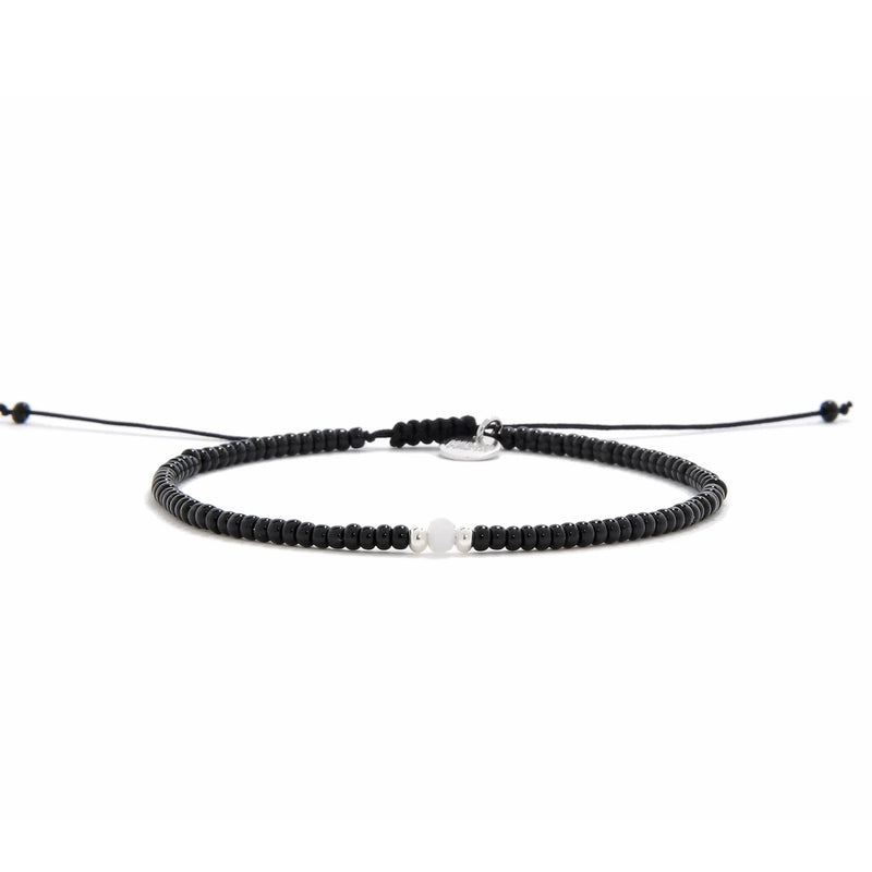 Bead Bracelet Black shown in full view with black seed beads with white accent beads and adjustable cord