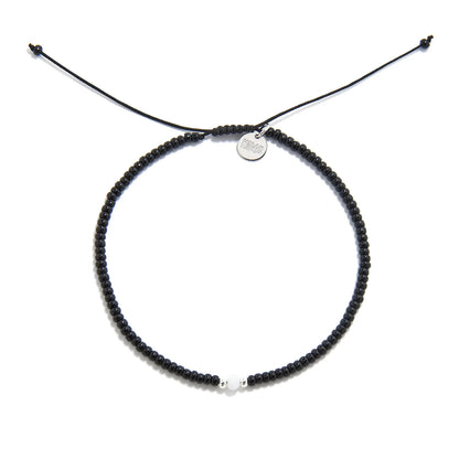 Bead Bracelet Black shown from above with black seed beads with white accent beads and round bracelet shape
