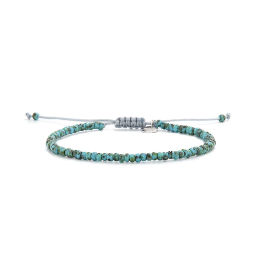 Bead Bracelet shown in full view with turquoise Picasso seed beads with gray cord and adjustable cord