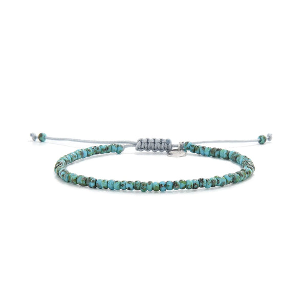 Bead Bracelet shown in full view with turquoise Picasso seed beads with gray cord and adjustable cord