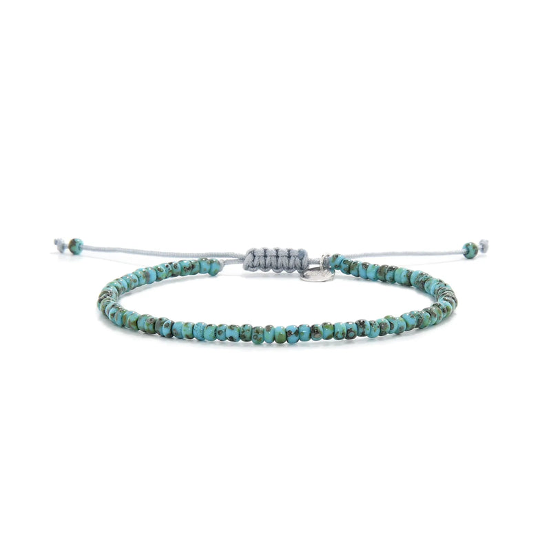 Bead Bracelet shown in full view with turquoise Picasso seed beads with gray cord and adjustable cord