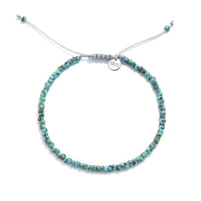 Bead Bracelet shown from above with turquoise Picasso seed beads with gray cord and round bracelet shape