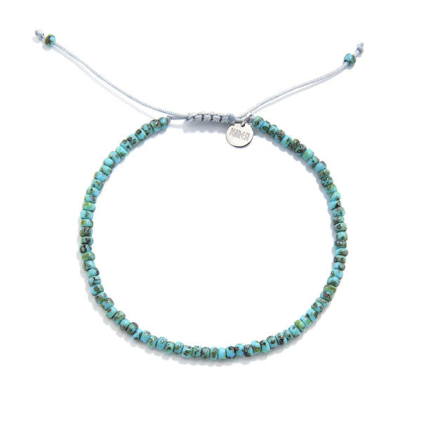 Bead Bracelet shown from above with turquoise Picasso seed beads with gray cord and round bracelet shape