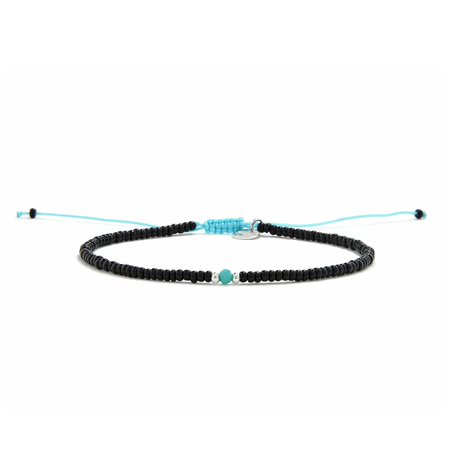 Beaded Bracelet shown in full view with black seed beads with turquoise accent beads and adjustable cord
