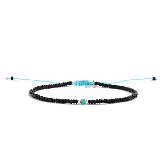Beaded Bracelet shown in full view with black seed beads with turquoise accent beads and adjustable cord