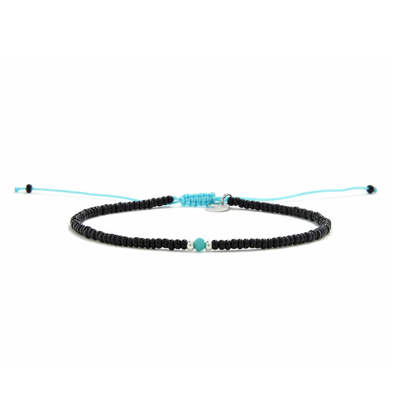 Beaded Bracelet shown in full view with black seed beads with turquoise accent beads and adjustable cord