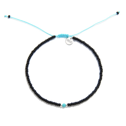 Beaded Bracelet shown from above with black seed beads with turquoise accent beads and round bracelet shape