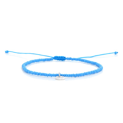Beaded Cross Bracelet shown in full view with turquoise seed beads with silver cross charm and adjustable cord