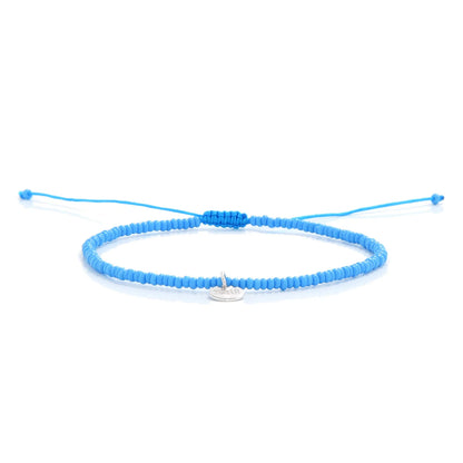 Beaded Cross Bracelet shown in full view with turquoise seed beads with silver cross charm and adjustable cord