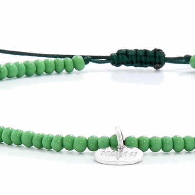 Detailed view of Beaded Stretch Bracelets with green seed beads with dark green cord, seed bead texture, and cord knot