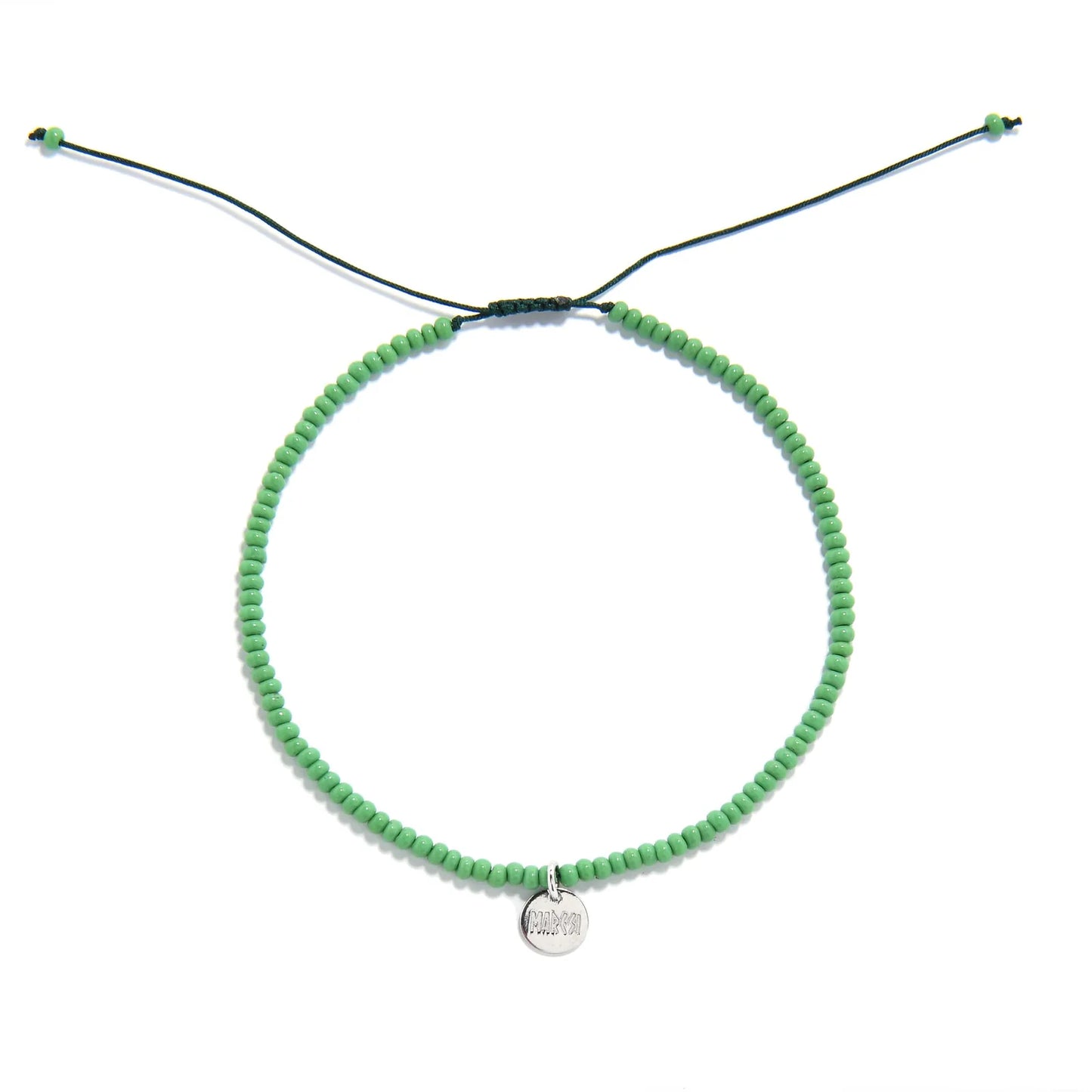 Beaded Stretch Bracelets shown from above with green seed beads with dark green cord and round bracelet shape