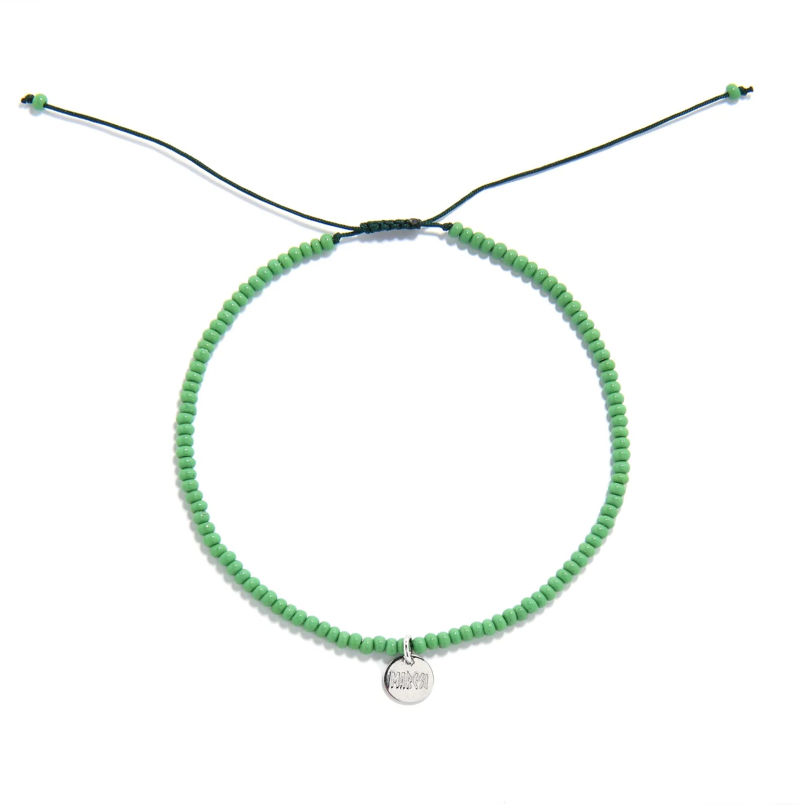 Beaded Stretch Bracelets shown from above with green seed beads with dark green cord and round bracelet shape