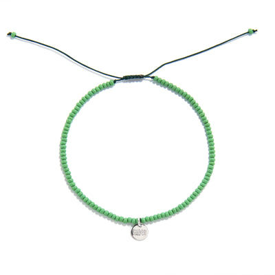 Beaded Stretch Bracelets shown from above with green seed beads with dark green cord and round bracelet shape