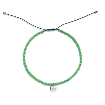 Beaded Stretch Bracelets shown from above with green seed beads with dark green cord and round bracelet shape