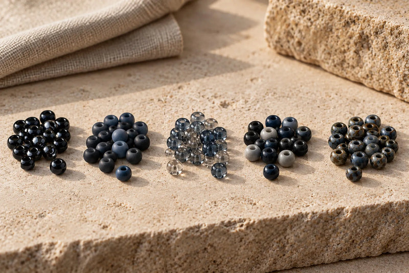 Beading Seed Beads in glossy black, matte blue, transparent gray, mixed opaque and mottled finishes.