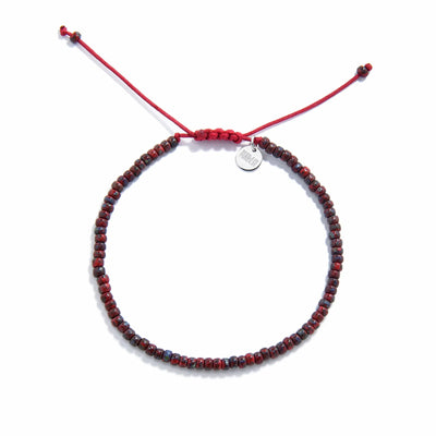 Beads Bracelets shown from above with red Picasso seed beads with red cord and round bracelet shape