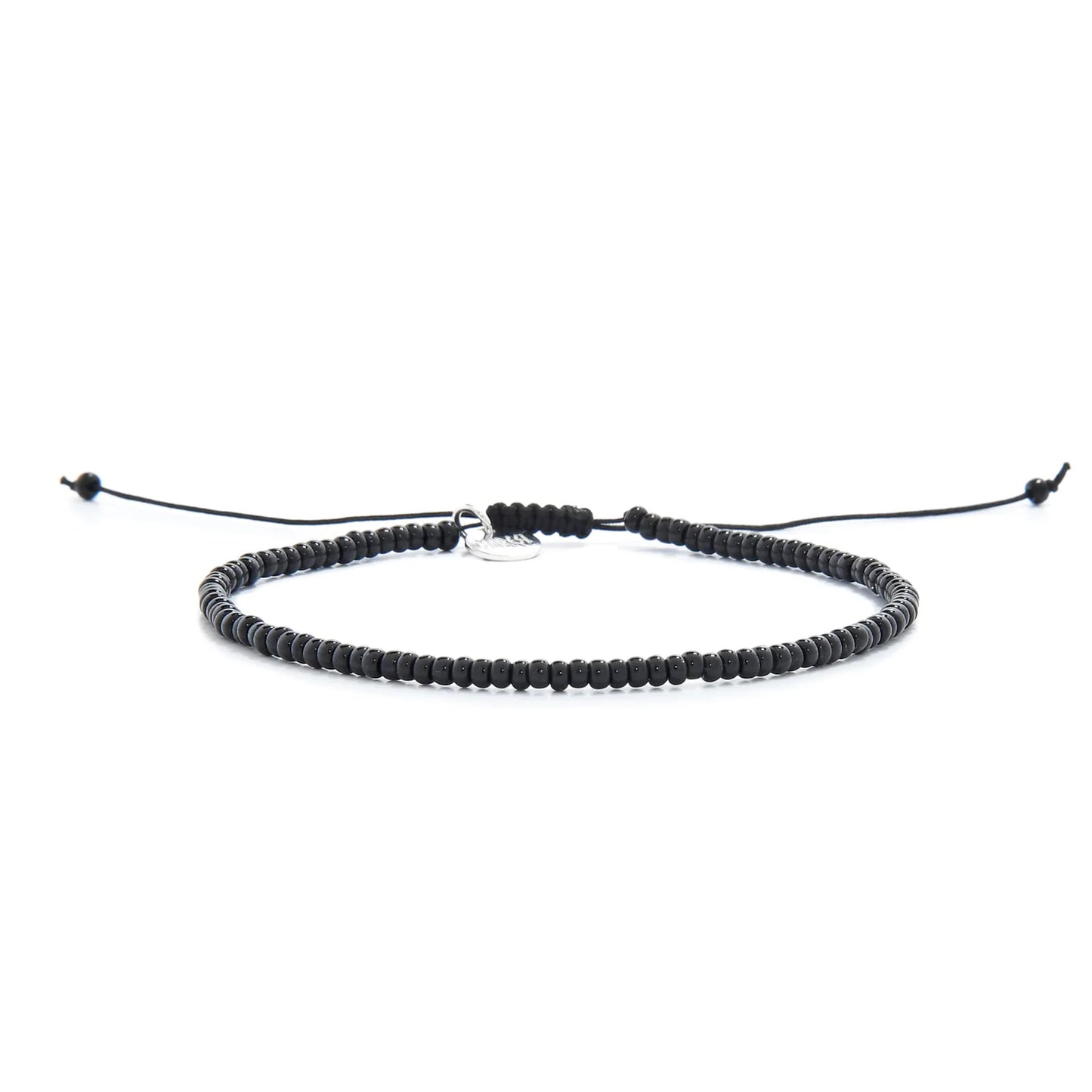 Black Bead Bracelet shown in full view with black seed beads with silver charm and adjustable cord