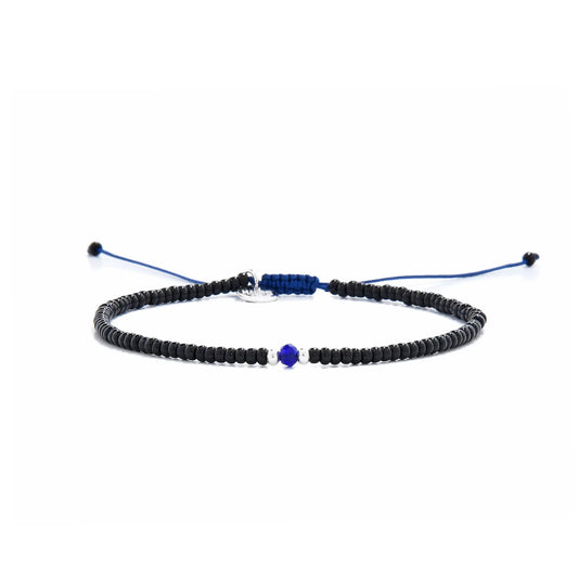 black and blue bead bracelet shown in full view with black seed beads with blue accent beads and adjustable cord