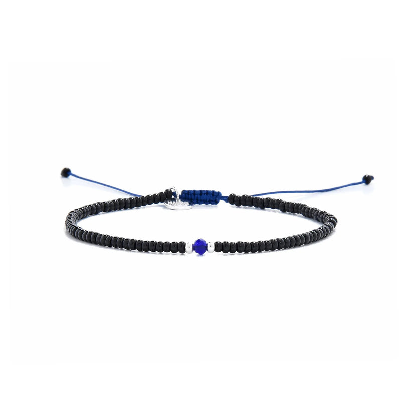 black and blue bead bracelet shown in full view with black seed beads with blue accent beads and adjustable cord