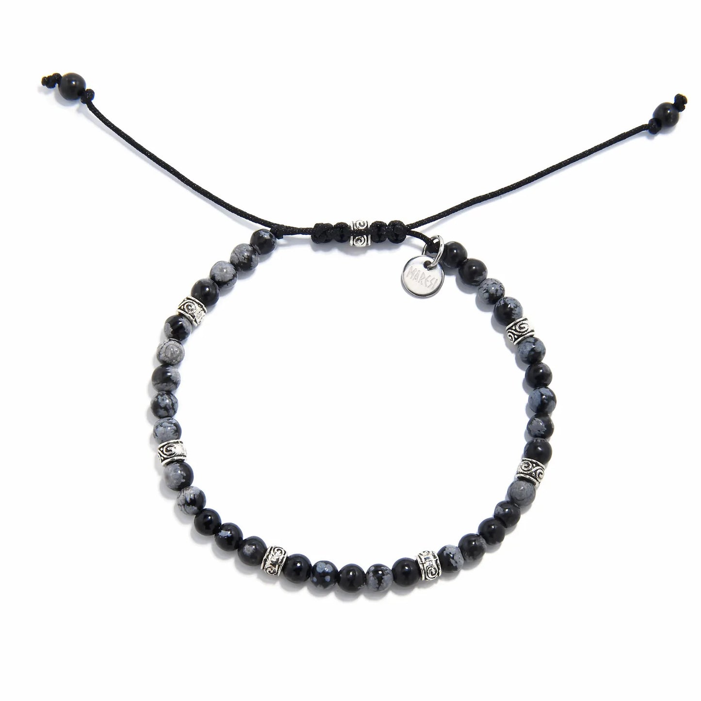 Adjustable black and silver bracelet with polished jasper beads and silver detailing, laid flat.
