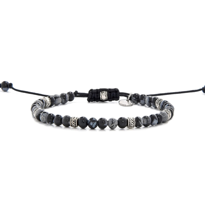 Full side view of the black and silver bracelet laid out flat with black cord and adjustable clasp.