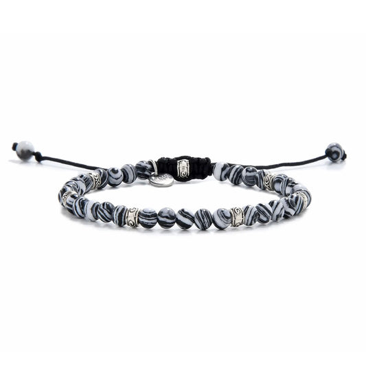 Full view of black and white beaded bracelet featuring striped black and white beads with silver spacers.