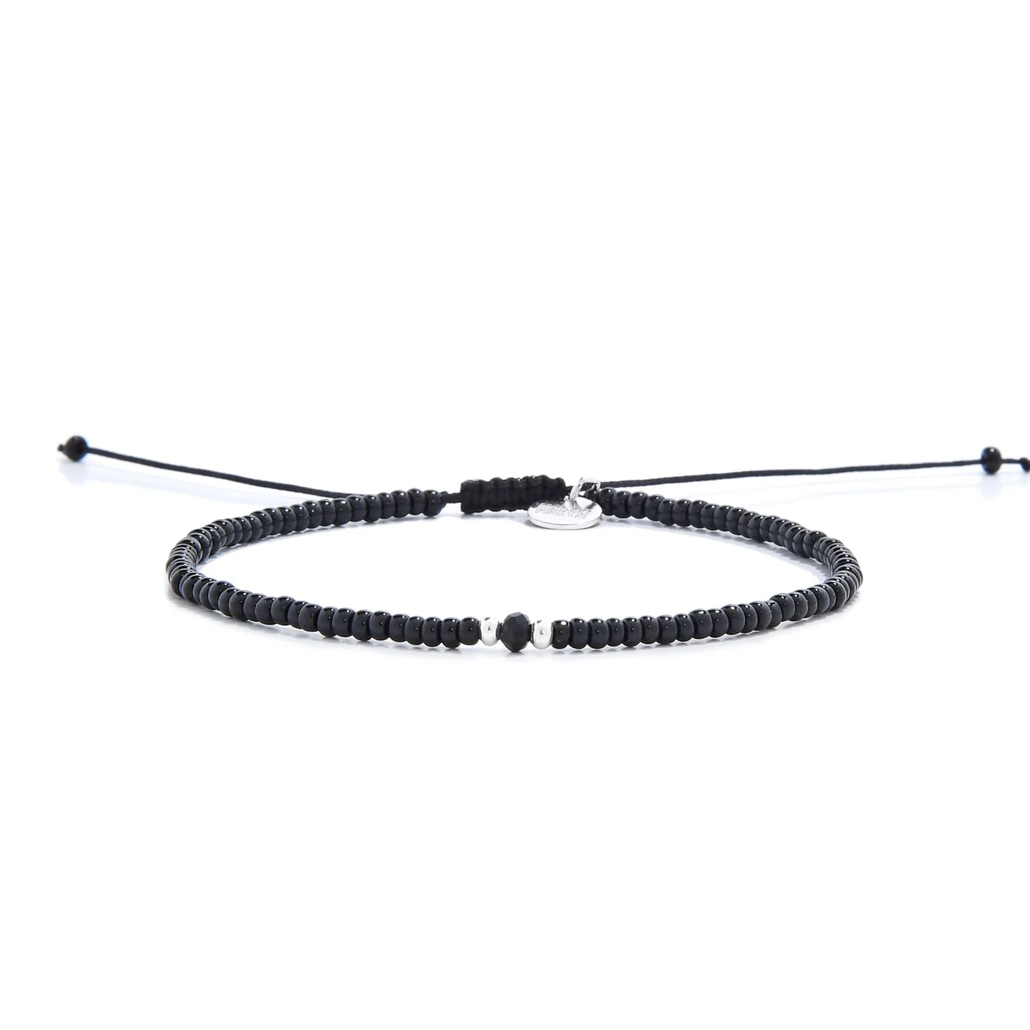 black crystal bracelet for men shown in full view with black seed beads with dark faceted accents and adjustable cord