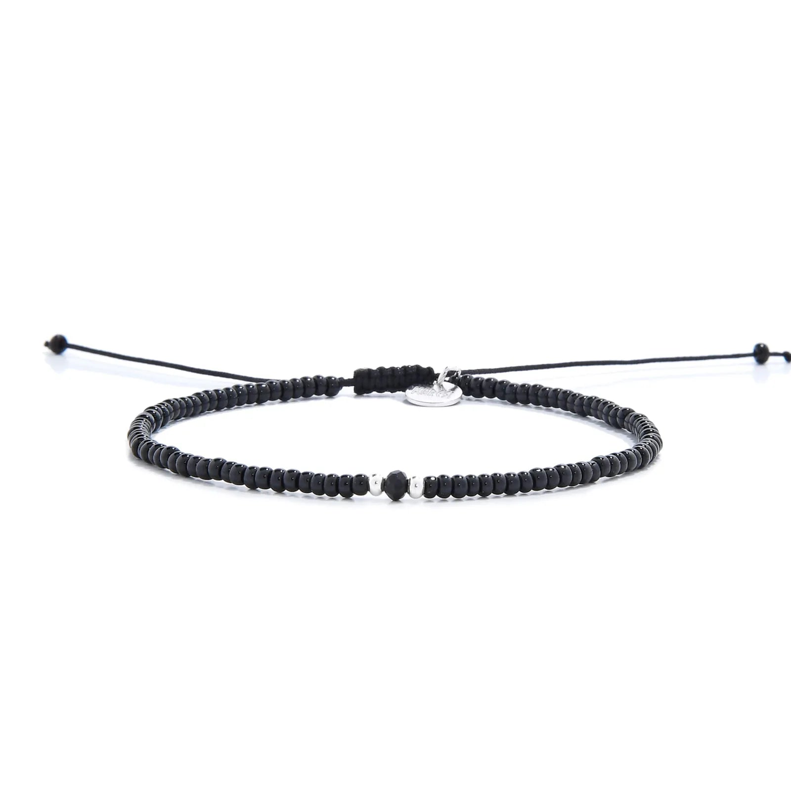 black crystal bracelet for men shown in full view with black seed beads with dark faceted accents and adjustable cord