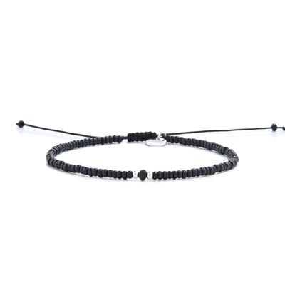 black crystal bracelet for men shown in full view with black seed beads with dark faceted accents and adjustable cord