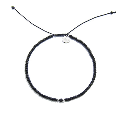 black crystal bracelet for men shown from above with black seed beads with dark faceted accents and round bracelet shape