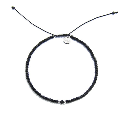 black crystal bracelet for men shown from above with black seed beads with dark faceted accents and round bracelet shape