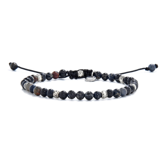 Black jasper beads bracelet featuring sea sediment stones and silver spacers laid flat.