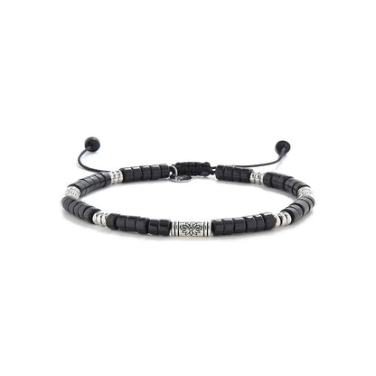 black shamballa bracelet shown in full view with black clay beads with engraved silver spacers and adjustable cord