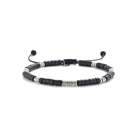 black shamballa bracelet shown in full view with black clay beads with engraved silver spacers and adjustable cord