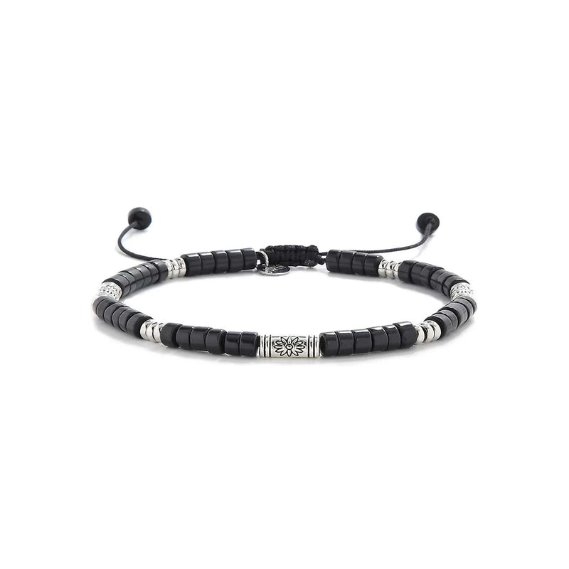 black shamballa bracelet shown in full view with black clay beads with engraved silver spacers and adjustable cord
