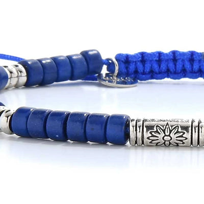 Detailed view of Blue Beads with blue clay beads with engraved silver spacers, Shamballa clay bead texture, and cord knot