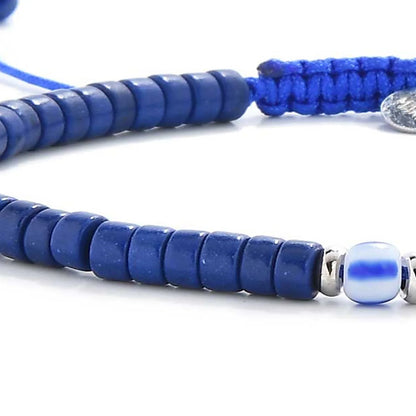 Detailed view of Blue Gemstone Jewelry with blue clay beads with blue accent bead, Santorini clay bead texture, and cord knot