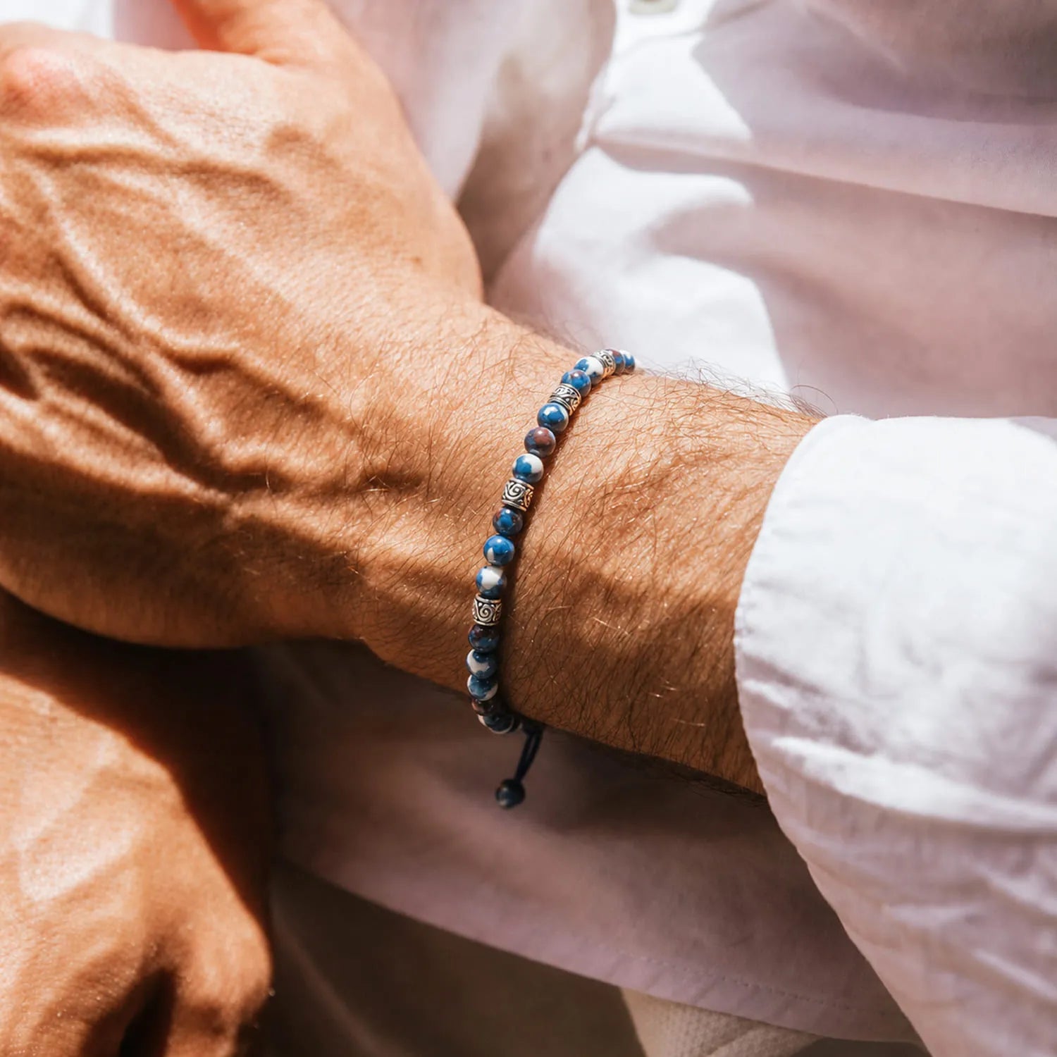 Blue Jasper Jewelry worn on a wrist with beaded design and adjustable cord