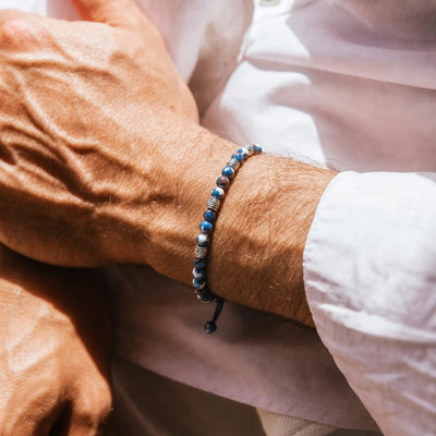 Blue Jasper Jewelry worn on a wrist with beaded design and adjustable cord