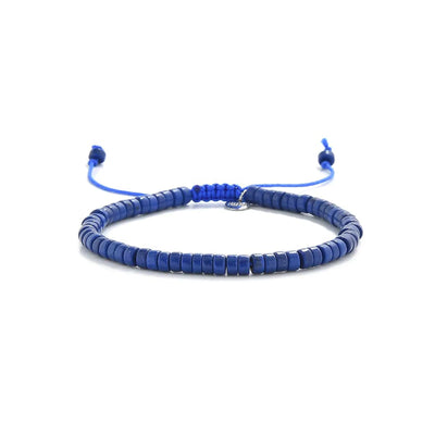 Blue Stone Bracelet shown in full view with blue clay beads with silver charm and adjustable cord
