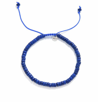 Blue Stone Bracelet shown from above with blue clay beads with silver charm and round bracelet shape