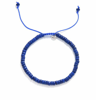 Blue Stone Bracelet shown from above with blue clay beads with silver charm and round bracelet shape