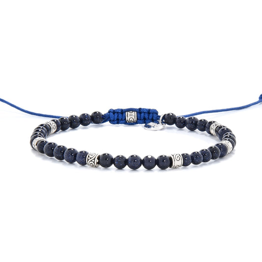 Quartz sandstone bracelet with silver spacers and blue cord, laid flat