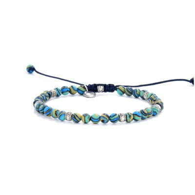 Bracelet Malachite full angled view with blue patterned beads, silver spacers, and drawcord closure